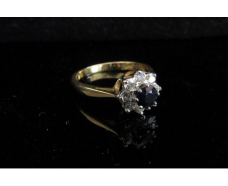 An 18ct gold sapphire and diamond cluster ring. Size M/N, 3.5g 