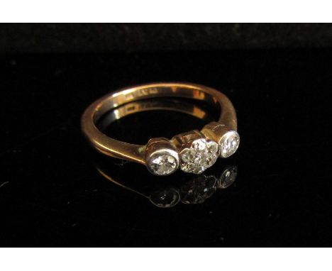 An 18ct gold platinum set three stone diamond ring in illusion setting. Size M, 2.8g 