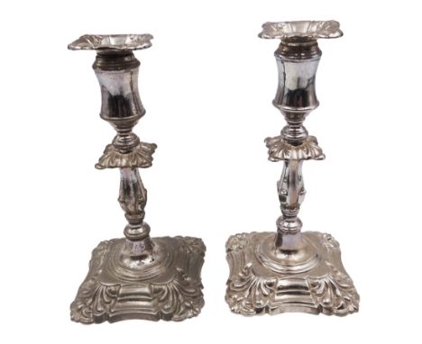 Pair of late Victorian silver mounted taper candlesticks, each of knopped and part fluted form, upon weighted square stepped 