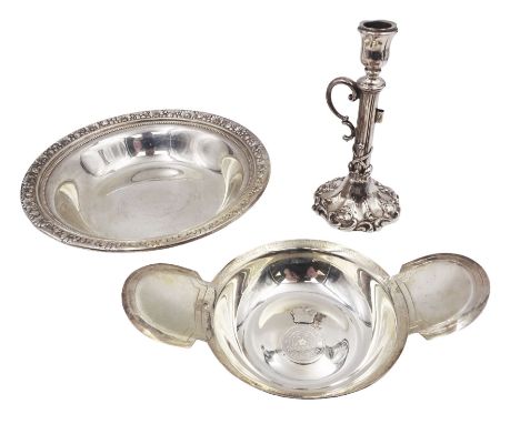 Victorian silver taper candlestick, with embossed foliate and floral decoration and C scroll handle, upon shaped foot, with s