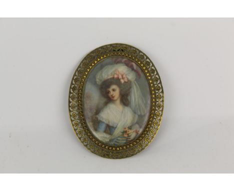 A late Georgian portrait miniature on ivory, depicting a lady in rich clothing, wearing ribbons and feathers in her hair, ind