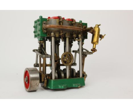 A kit built model live steam vertical engine with twin cylinders and double acting side valves, 14.5cm high 