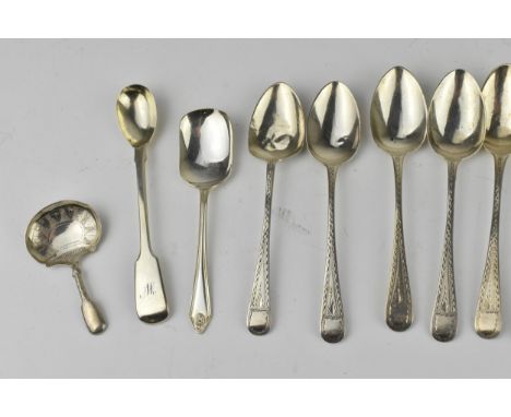 A set of George III silver tea spoons, some by Thomas Wilkes Barker, dates between 1799 and 1828, all with bright cut design,