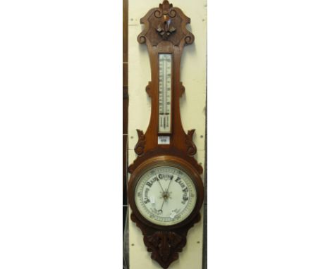 20th Century carved oak aneroid barometer.(B.P. 24% incl. VAT)