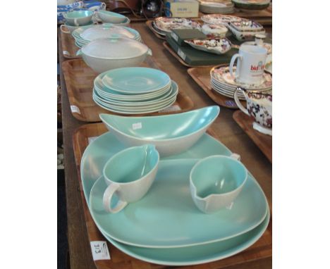 Three trays of Poole Pottery dinnerware items on a turquoise ground comprising: two handled bowls and saucers; tureen; gravy 
