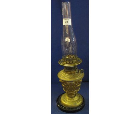 Early 20th Century brass double burner oil lamp with gilded metal, urn shaped reservoir and base on a ceramic plinth with cle