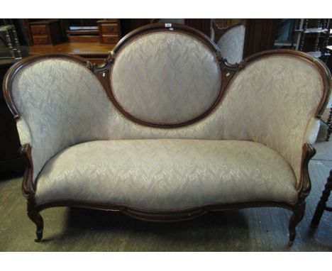 Late 19th/early 20th Century mahogany show frame upholstered, double ended sofa, on cabriole legs and casters.(B.P. 24% incl.