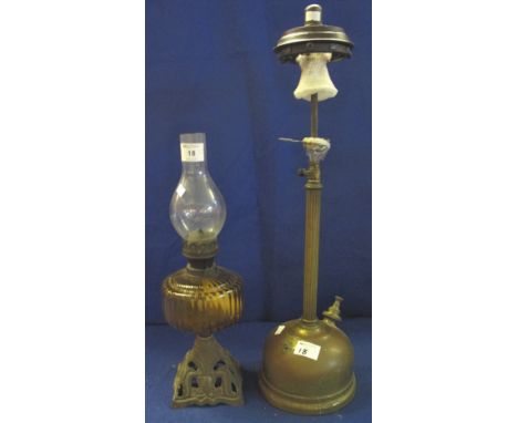 Early 20th Century brass single burner oil lamp with coloured glass reservoir and pierced cast metal base with clear chimney,