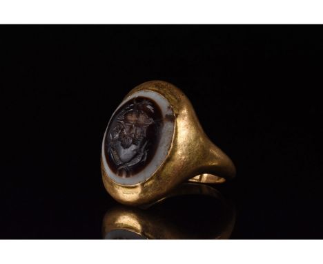 C. 224 to 651 AD. Sassanian. Gold ring with a D-shaped loop into which is set a red gem intaglio bearing a a double portriat 