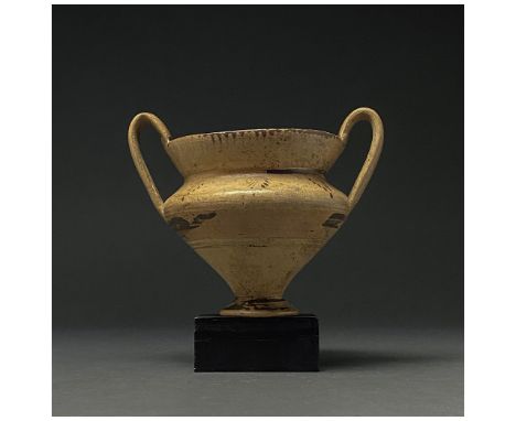 600-200 BC. Apulia. A Daunian terracotta cup with a flaring rim, carinated body, ring foot, and two high, ear-shaped handles.