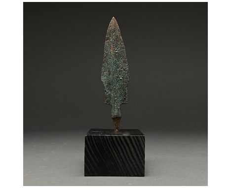 1200-700 BC, Greek Archaic Period. A bronze spearhead with a lanceolate blade with flaring shoulders, raised midrib, short ne