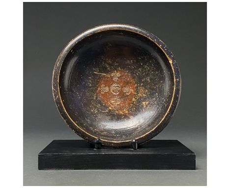 C.. 200-100 BC. Late Hellenistic. A terracotta plate with out-turned rim, hemispherical body and ring foot; an incised stylis