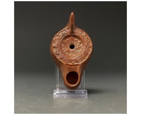 C. 100-300. Roman. A beautiful terracotta oil lamp with ribbed disk, bearing two registers of alternating circle and triangle