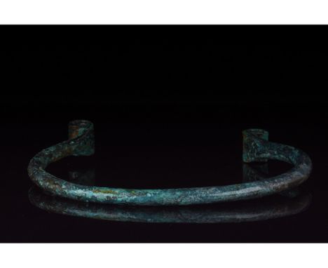 1000 â€“ 600 BC, Bronze Age. This thick and heavy bronze torc has a simple single strand design, with highly decorative recur