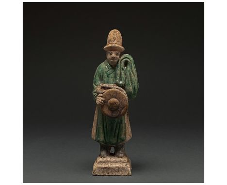 Ca. 1368-1644 AD. Chinese Ming Dynasty. An elaborately crafted male attendant figure dressed in a dark green tunic with orang