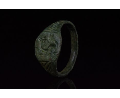 700-1100 AD, Viking Age. Bronze ring with a circular hoop, and an octagonal bezel which bears incised decoration in the form 