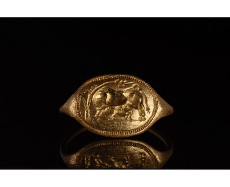 100-300 AD. Roman. Gold ring with a D-shaped hoop and bulging elliptical plate bearing an engraved depiction of a cow and her