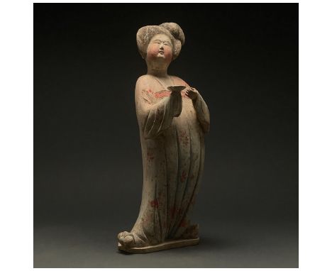 Ca. 618-907 AD. Chinese Tang Dynasty. A ceramic â€˜Fat Ladyâ€™ figure. The figure stands facing forward, with one foot angled