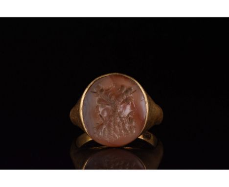 C. 100-300 AD. Roman. Gold ring comprising circular hoop and round bezel with a carnelian setting. The setting bears an engra