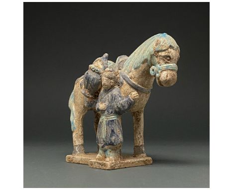 Ca. 1368-1644 AD. Chinese Ming Dynasty. Ceramic horse and groom figurine. This figurine shows a groom, dressed in a dark blue