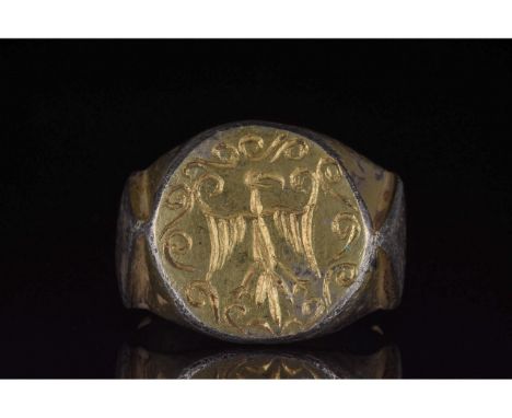 C. 1100-1300 AD. Byzantine. A large silver gilt ring with a circular hoop, heavy band featuring lozenge-shaped decoration on 