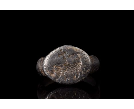 1100-1300 AD. Medieval. A rare silver ring with a circular hoop, scalloped shoulders and elliptical plate bezel bearing an en