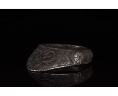 Ca. 1200 AD, Medieval. A silver archerâ€™s ring comprising a circular hoop and projecting triangular guard. The exterior of t
