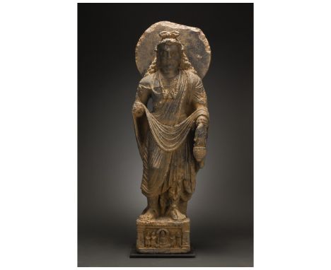 100-300 AD. Gandharan. A giant schist figure of a bodhisattva, backed by a halo, who stands, gazing serenely into the distanc