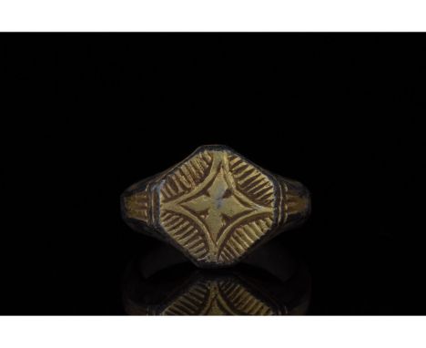 c. 1000-1500 AD, Crusader Period. Silver gilt ring with a thick circular hoop and a octagonal bezel featuring an incised Star