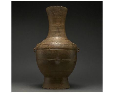 Ca. 206 BC-220 AD. Han Dynasty. A beautiful rare ceramic vase with a beige fabric and glossy brown slip. The vase comprises a