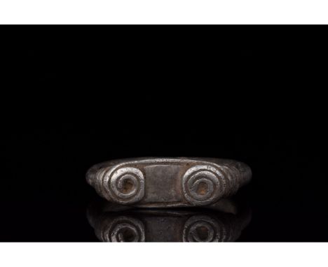 700-1100 AD, Viking Age. A silver with a D-shaped hoop, and elliptical bezel affixed to the hoop by applied coils of silver w