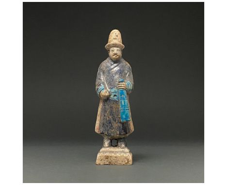 Ca. 1368-1644 AD. Chinese Ming Dynasty. An elaborately crafted male attendant figure dressed a dark blue tunit with red side 