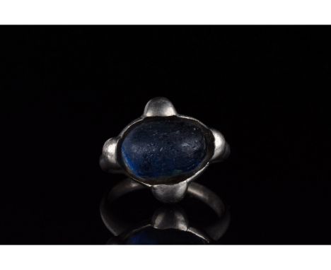 700-1100 AD, Viking Age. Silver ring with a circular hoop, and a lozenge shaped bezel onto which is mounted a large, oval blu