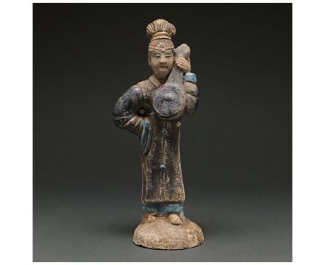 Ca. 1368-1644 AD. Chinese Ming Dynasty. An elaborately crafted female attendant figure dressed in a dark over-dress with blue