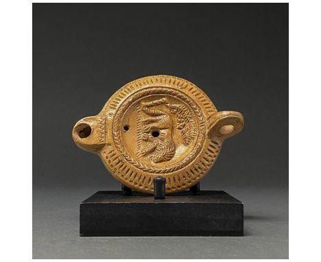 50-100 AD. Roman. A gorgeous light brown terracotta oil lamp with a loop handle and snub spout. Oil the lampâ€™s disk bears a