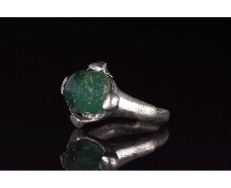 700-1100 AD, Viking Age. Silver ring with a circular hoop, and a lozenge shaped bezel onto which is mounted a large, circular