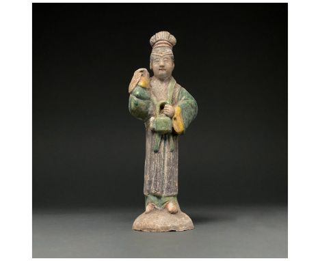 Ca. 1368-1644 AD. Chinese Ming Dynasty. An elaborately crafted female attendant figure dressed in a bright green dress with y