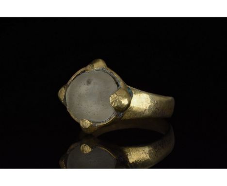 700-1100 AD, Viking Age. Silver gilt ring with a circular hoop, and a lozenge shaped bezel onto which is mounted a large, cir