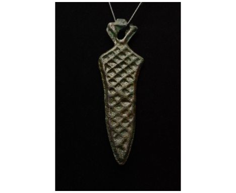 Ca. 700-1100 AD. Viking Age. A bronze pendant in the shape of sword comprising an openwork triangular pommel, short handle lo