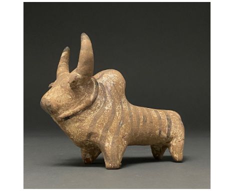 C. 3rd millennium BC. Indus Valley. An creme-coloured ceramic figurine of a zebu with exaggerated crescent horns, painted wit