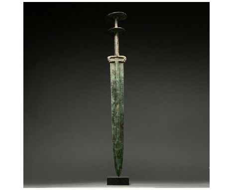 1200-700 BC This beautiful cast bronze sword has a tapering, bevelled blade with a raised midrib and beautiful integral handl