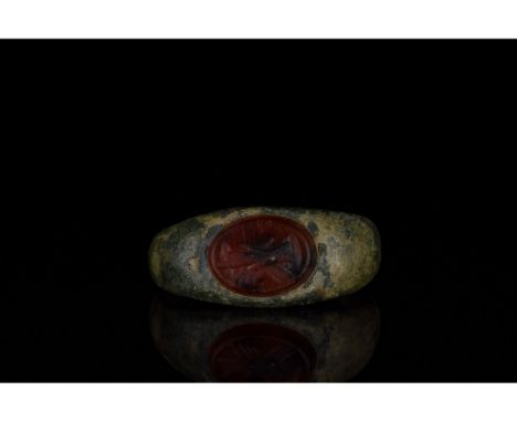 100-300 AD, Roman. Bronze ring with a D-Shaped hoop, and an oval-shaped red intaglio with 'dextrarum iunctio' ('joining toget