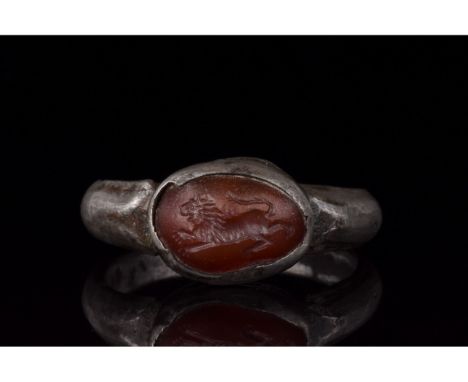 C. 100-300 AD. Roman. Silver ring comprising circular hoop a raised elliptical bezel with a red gem setting. The setting bear