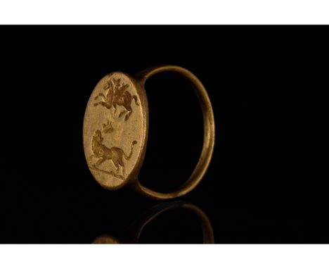 C. 100 AD, Roman. Well-preserved Gold ring with circular hoop and flattend round bezel featuring and engraved lion and grypho