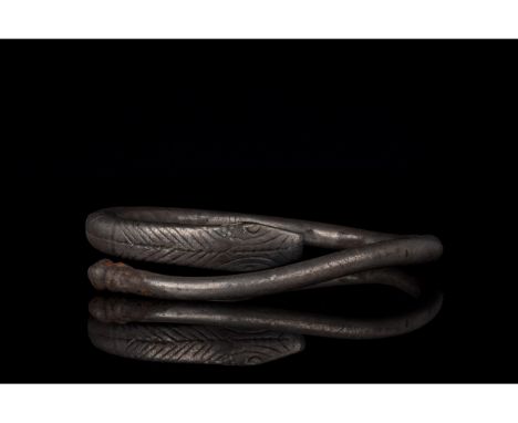 700-1100 AD, Viking Age. A fine silver bracelet comprised of a single strand of silver with one terminal shaped into a trunca