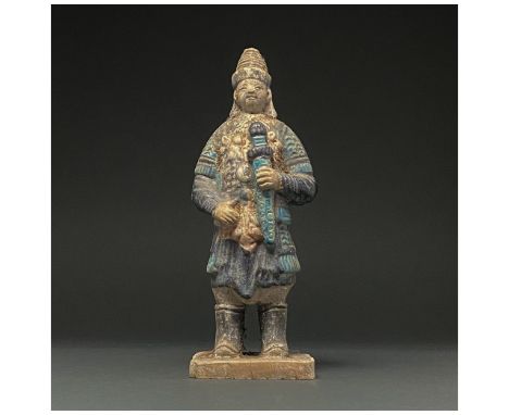 Ca. 1368-1644 AD. Chinese Ming Dynasty. An elaborately crafted warrior attendant figure dressed in intricate light and dark b