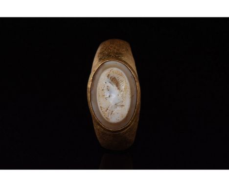 C. 100-300 AD. Roman. Gold ring comprising D-shaped hoop and elliptical bezel with a pale setting. The setting bears an engra