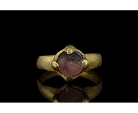 700-1100 AD, Viking Age. Silver gilt ring with a circular hoop, and a lozenge shaped bezel onto which is mounted a large, cir