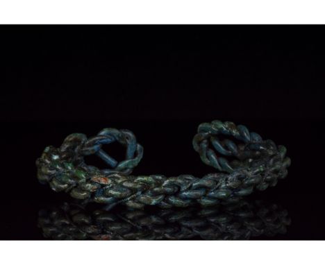 700-1100 AD, Viking Age. A heavy bronze twisted bracelet comprising several strands of bronze woven together with loop termin