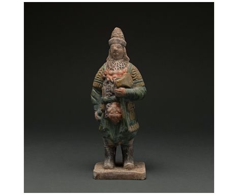 Ca. 1368-1644 AD. Chinese Ming Dynasty. An elaborately crafted warrior attendant figure dressed and green and orange armour, 